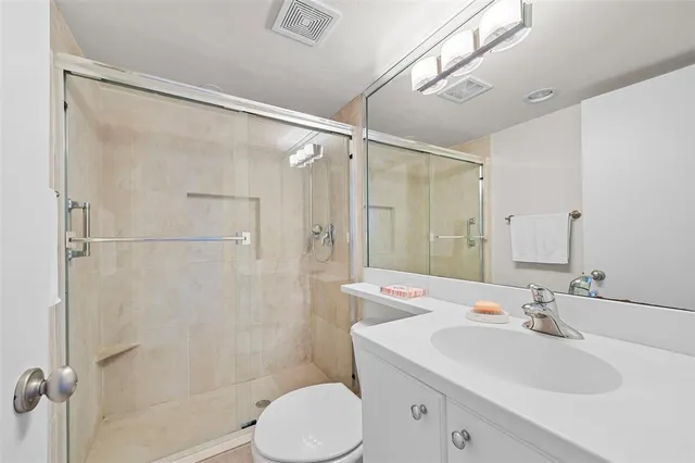 a bathroom with a sink toilet and shower