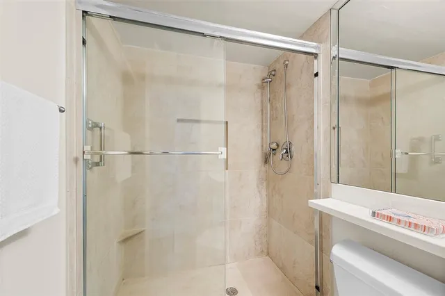 a bathroom with a shower and a shower