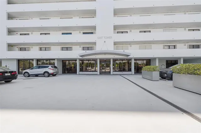 a couple of cars parked in front of building