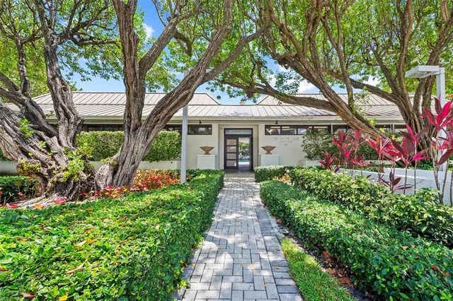 a front view of a house with a garden