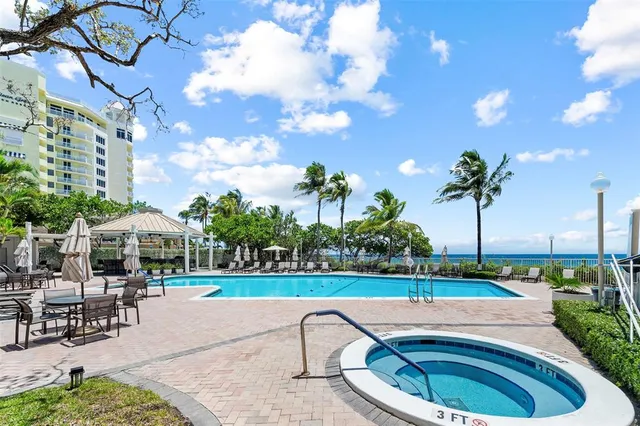 a swimming pool with outdoor seating and yard