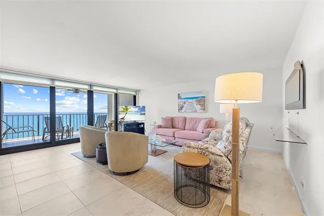 a living room with fireplace furniture and a floor to ceiling window