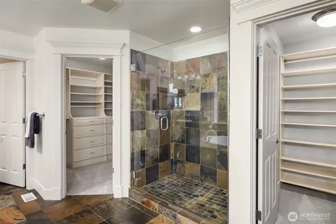 a bathroom with a shower and a glass door
