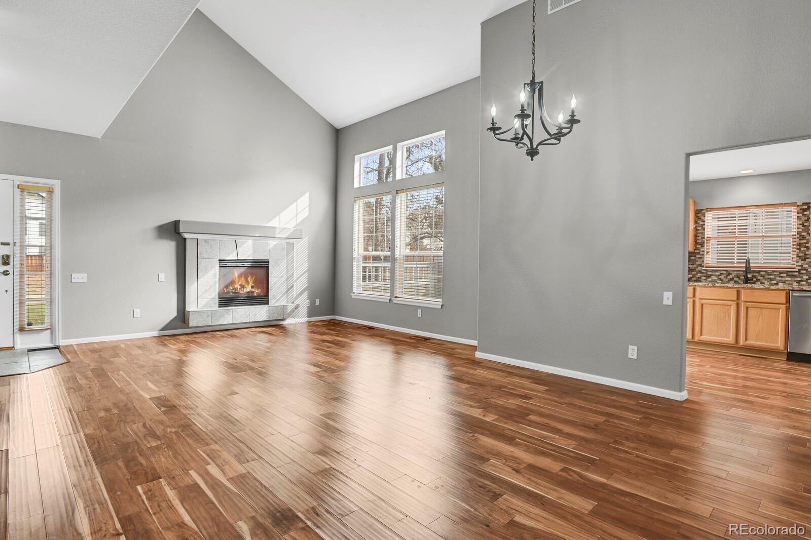 6141 Trailhead Road Highlands Ranch, CO 80130 - Photo 11 of 42 a view of an empty room with a window and wooden floor