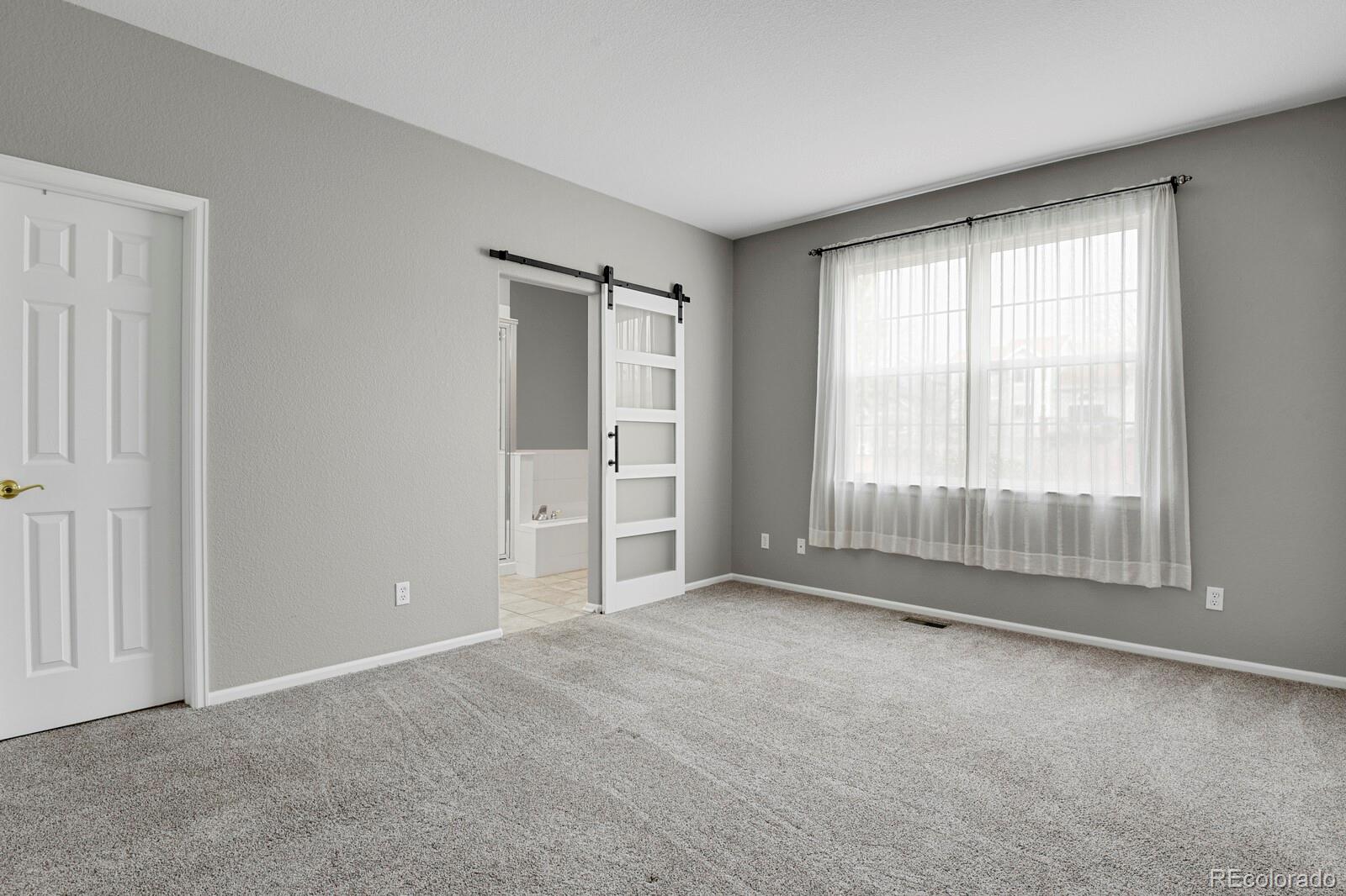 6141 Trailhead Road Highlands Ranch, CO 80130 - Photo 17 of 42 a view of an empty room with a window