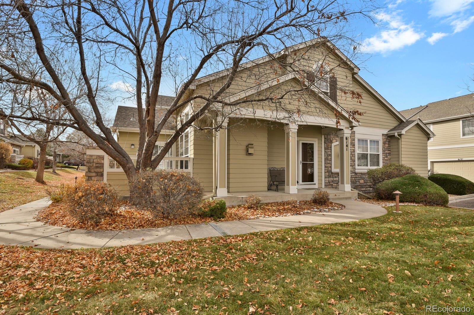 6141 Trailhead Road Highlands Ranch, CO 80130 - Photo 2 of 42 a front view of a house with a yard
