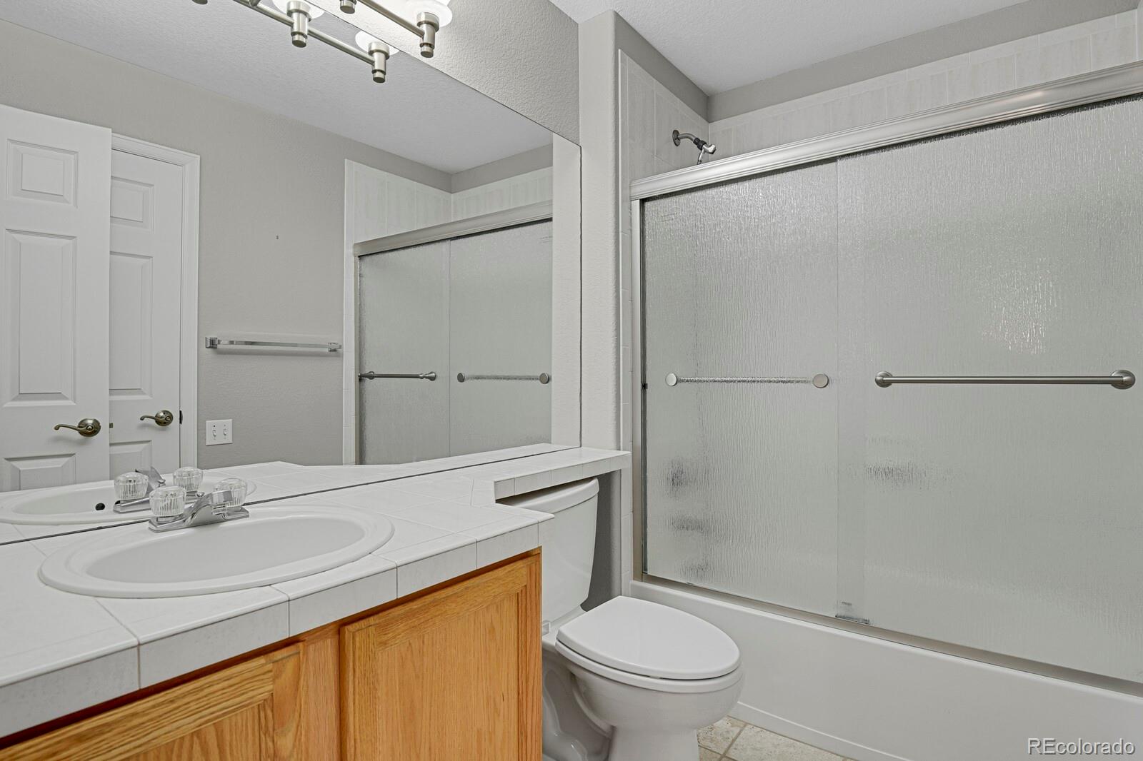 6141 Trailhead Road Highlands Ranch, CO 80130 - Photo 24 of 42 a bathroom with a sink toilet and shower