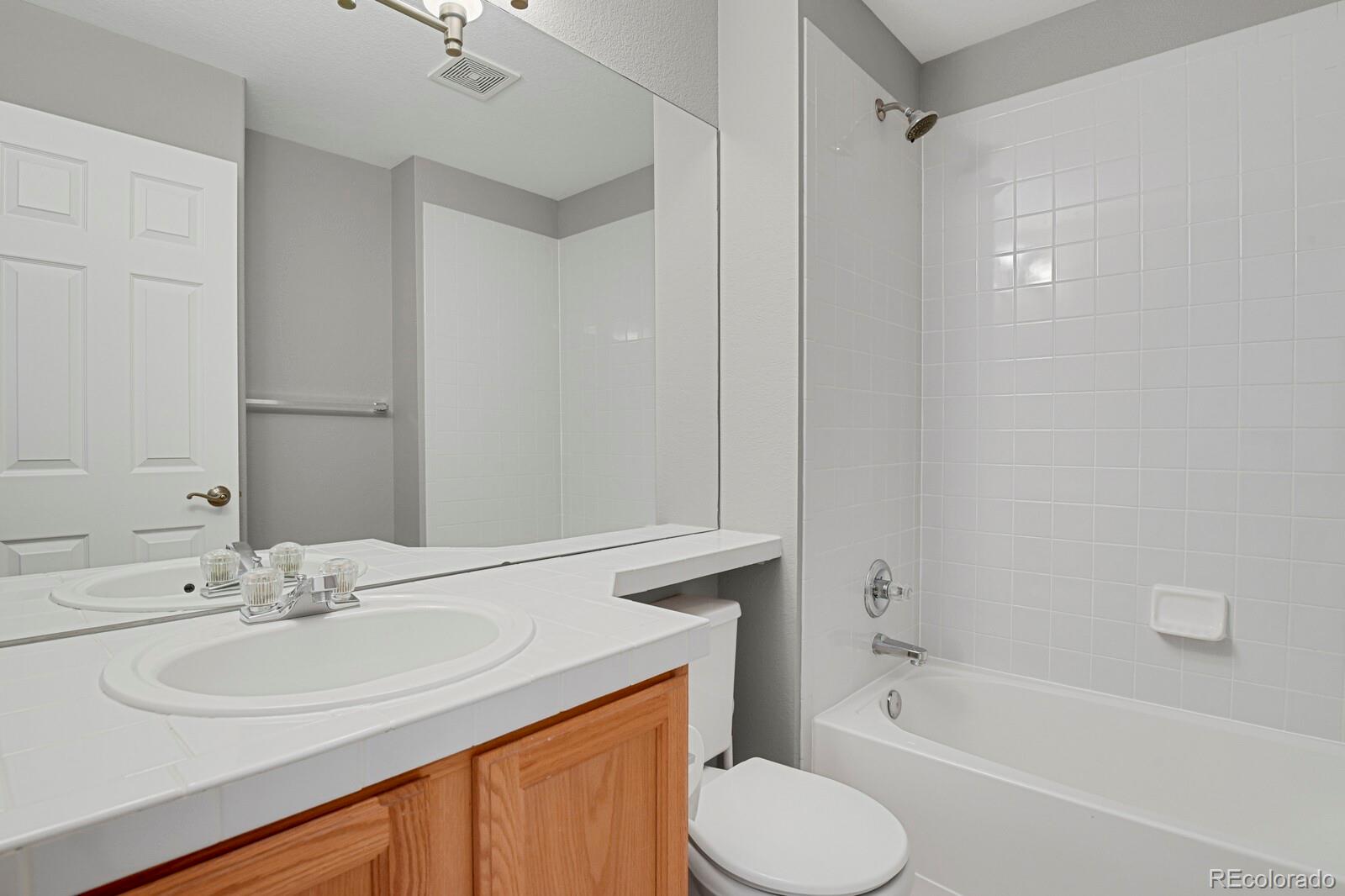6141 Trailhead Road Highlands Ranch, CO 80130 - Photo 29 of 42 a bathroom with a sink toilet and shower