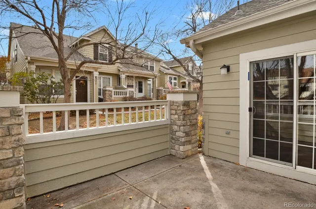 a view of a house with a small yard and wooden fence