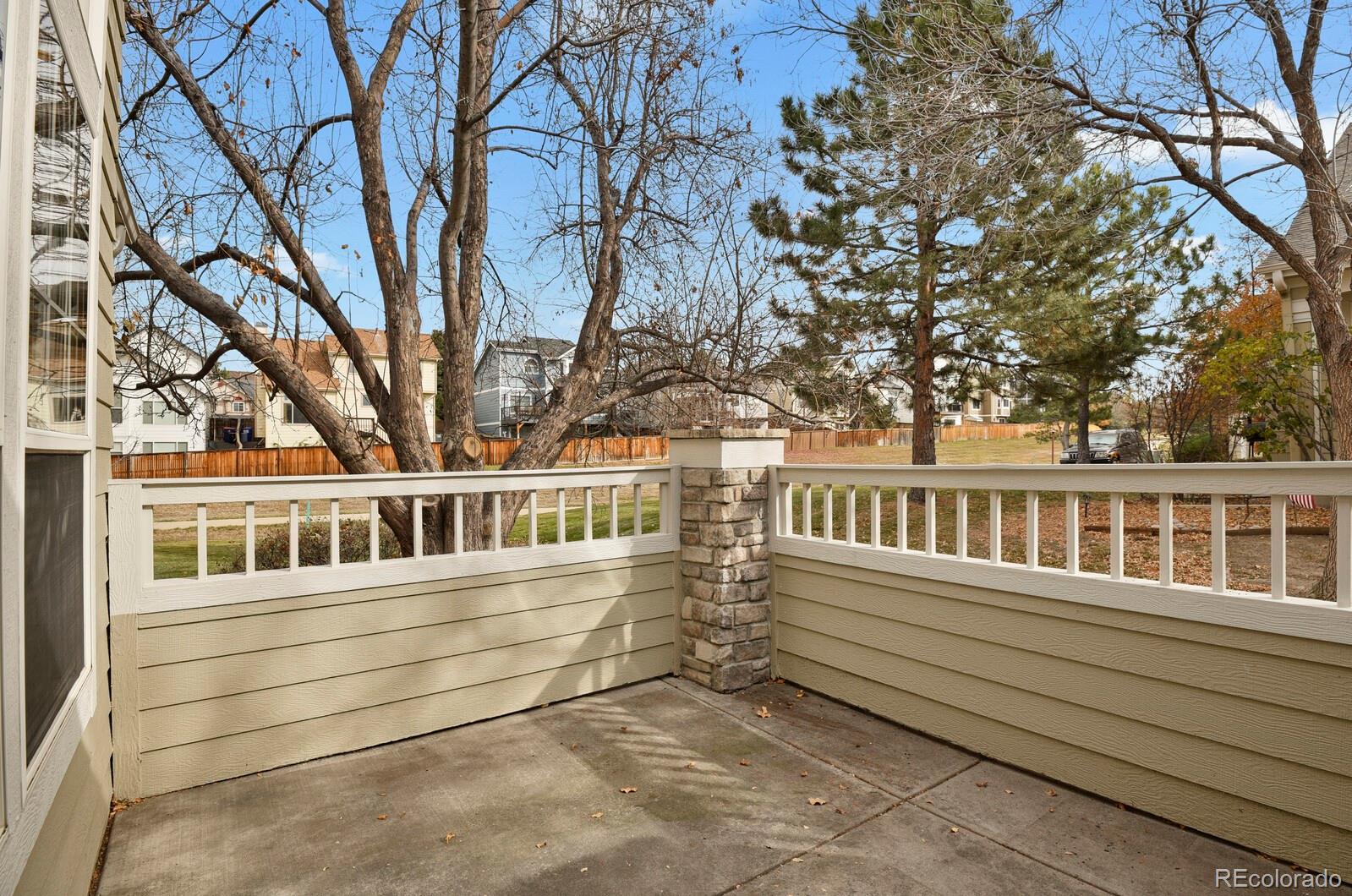 6141 Trailhead Road Highlands Ranch, CO 80130 - Photo 33 of 42 a view of a house with a small yard and wooden fence