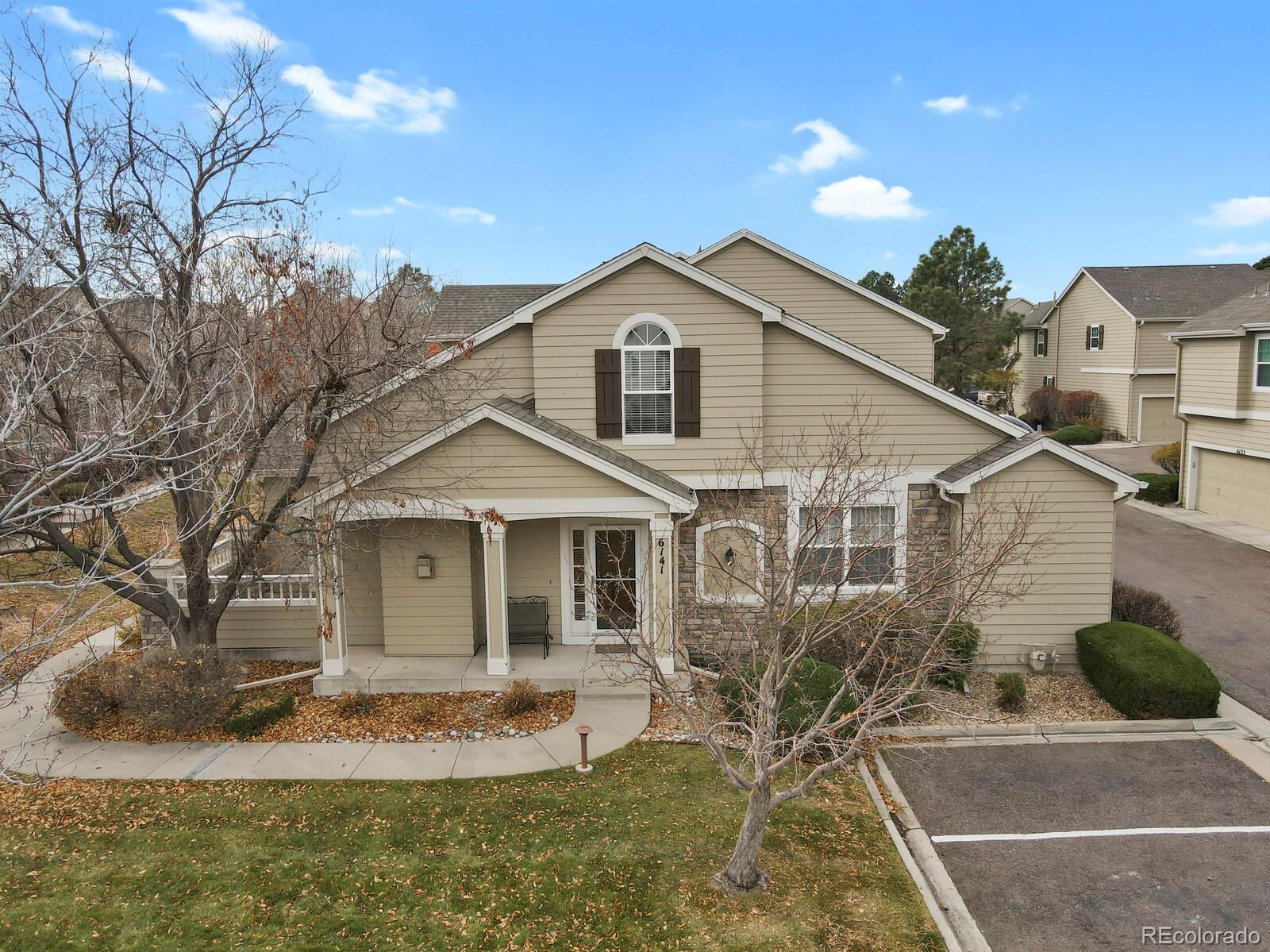 6141 Trailhead Road Highlands Ranch, CO 80130 - Photo 36 of 42 a view of a white house next to a yard with big trees