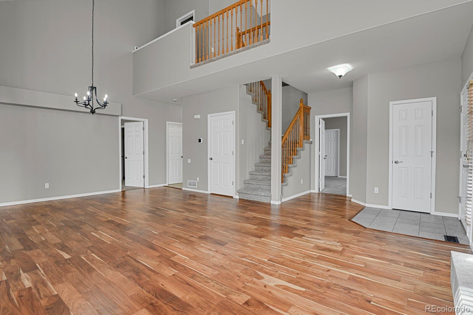 6141 Trailhead Road Highlands Ranch, CO 80130 - Photo 6 of 42 a view of an empty room with wooden floor and entryway