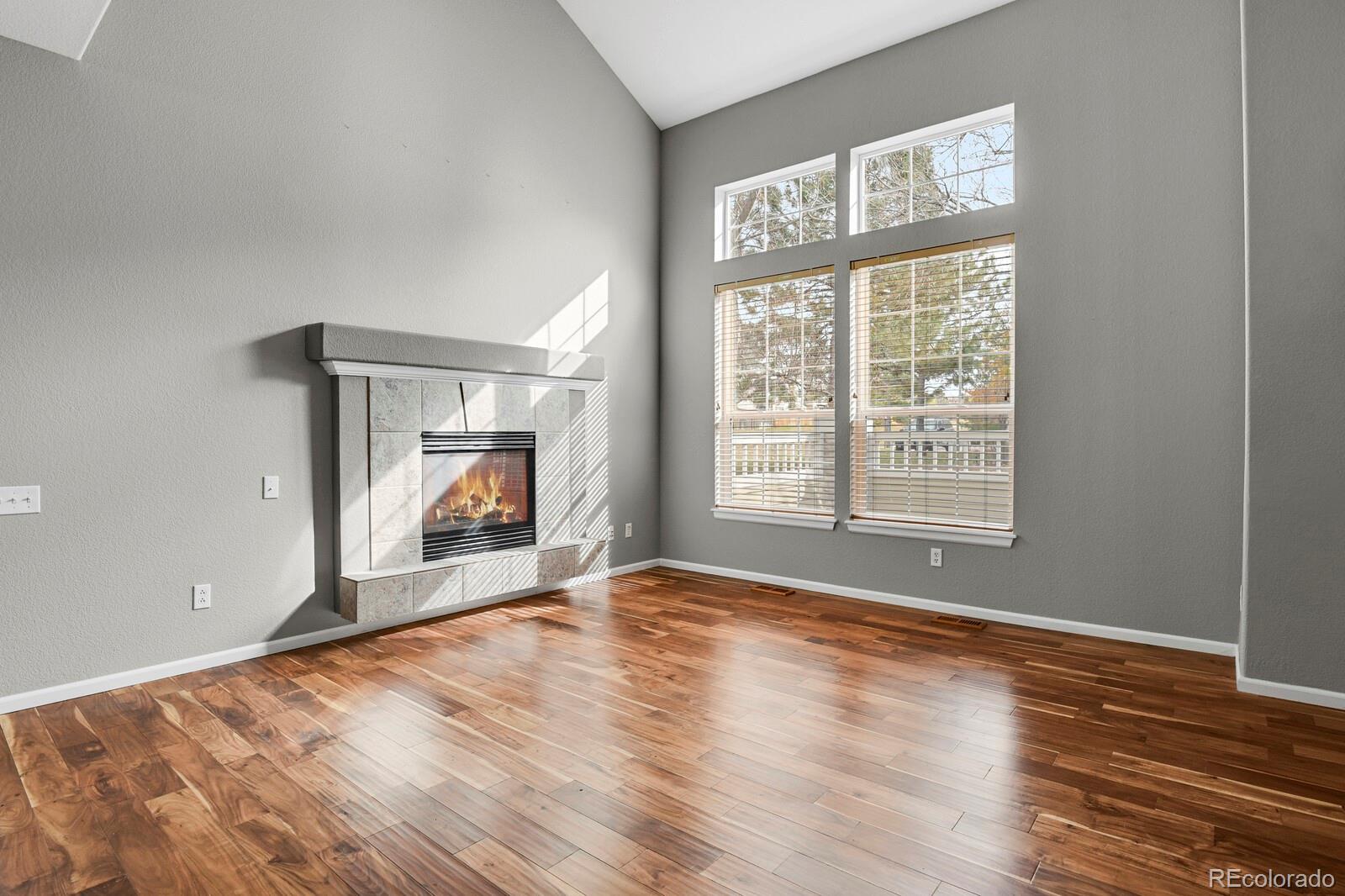 6141 Trailhead Road Highlands Ranch, CO 80130 - Photo 7 of 42 a view of an empty room with wooden floor and a window