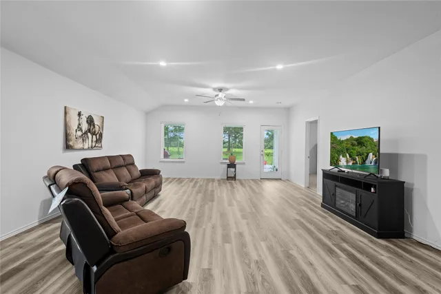 a large kitchen with granite countertop lots of counter space and stainless steel appliances