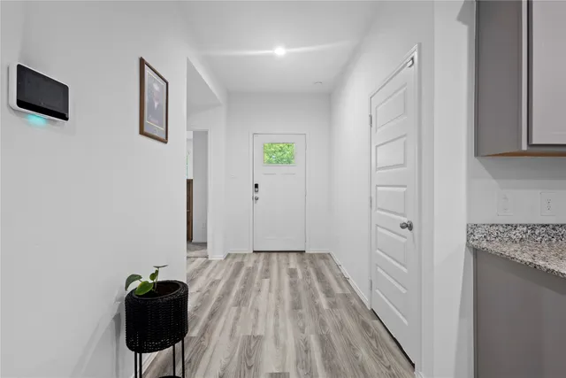 a spacious bedroom with a bed and a dresser