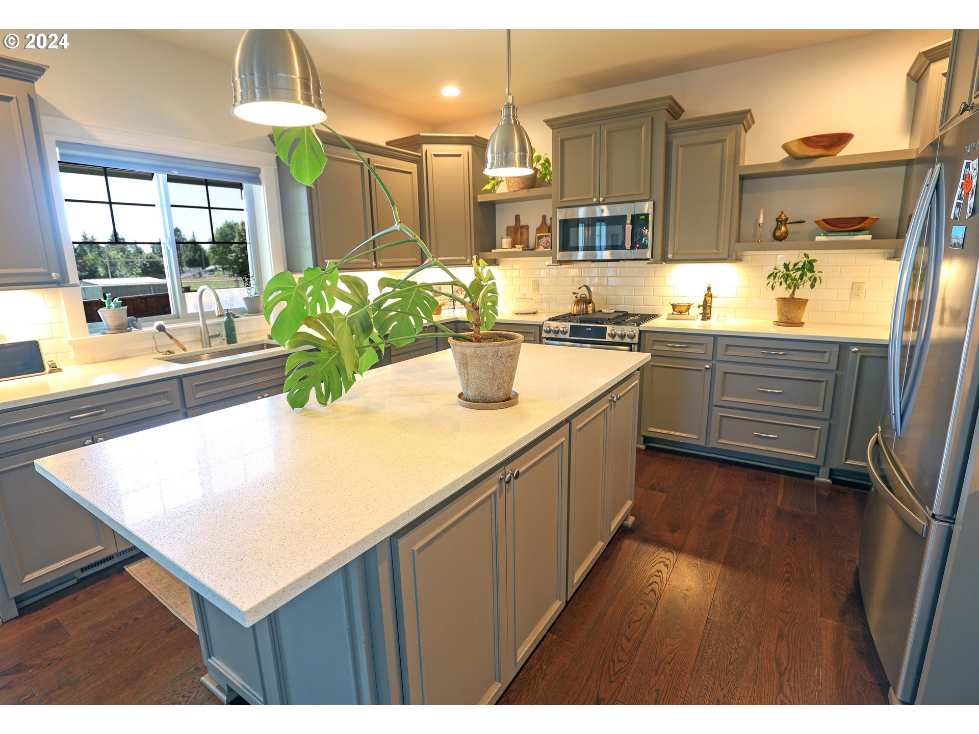 2230 Jeppesen Acres Road Eugene, OR 97401 - Photo 9 of 39 a kitchen with stainless steel appliances kitchen island granite countertop a sink and counter space
