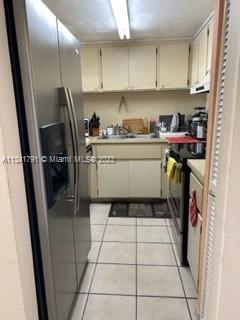 Westchester Miami, FL 33144 - Photo 3 of 9 a kitchen with a sink a stove and refrigerator