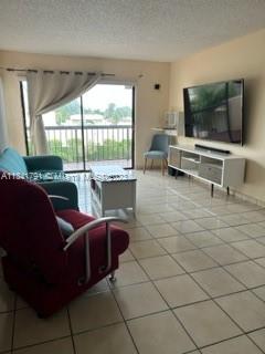 Westchester Miami, FL 33144 - Photo 4 of 9 a living room with furniture and a flat screen tv