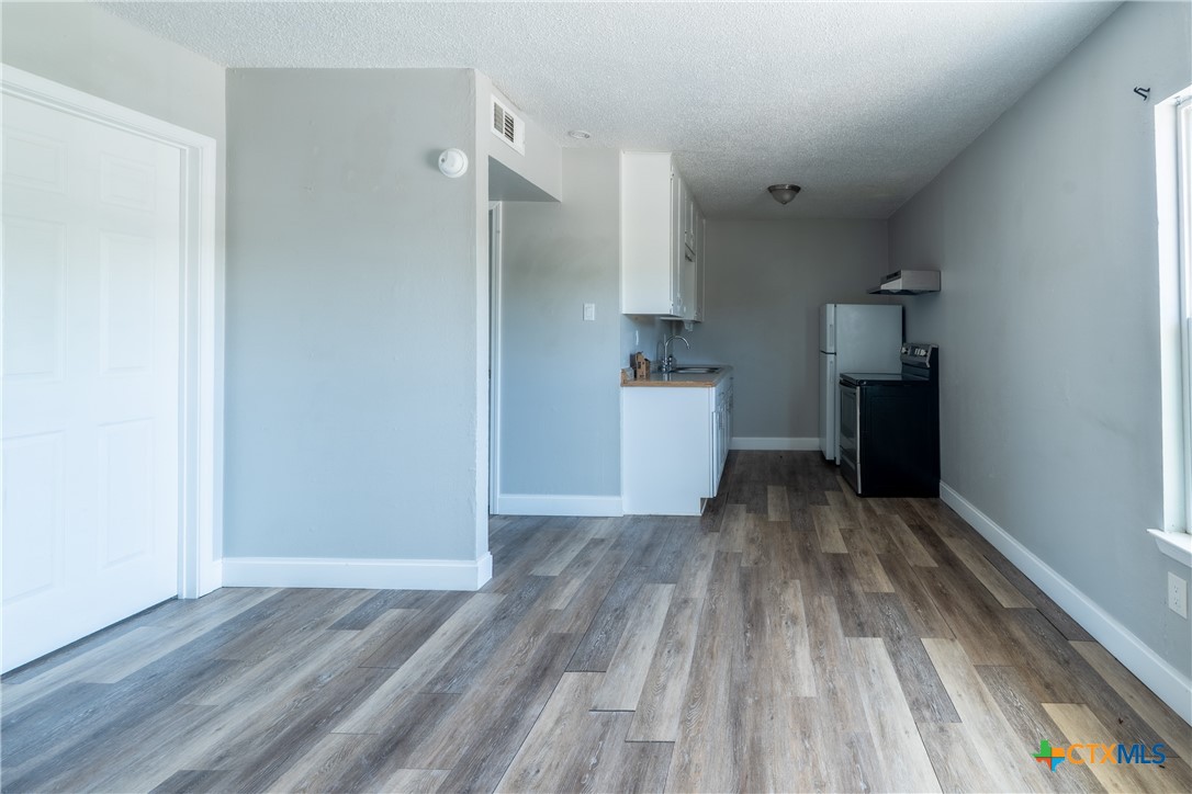 512 Sunset Lane, Unit AD Copperas Cove, TX 76522 - Photo 19 of 23 a view of a kitchen with wooden floor