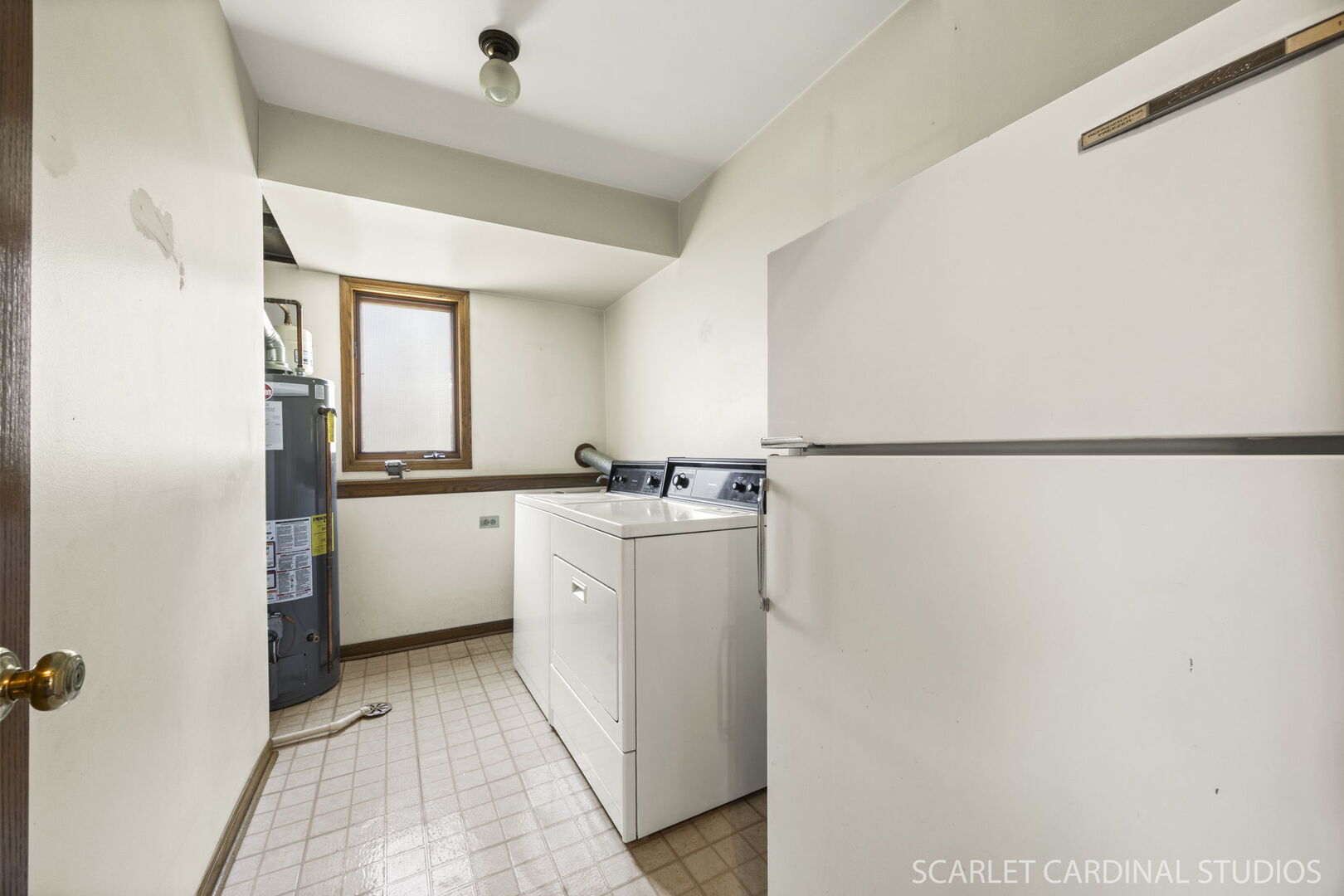 8214 45th Street Lyons, IL 60534 - Photo 17 of 24 a kitchen with a refrigerator and white cabinets