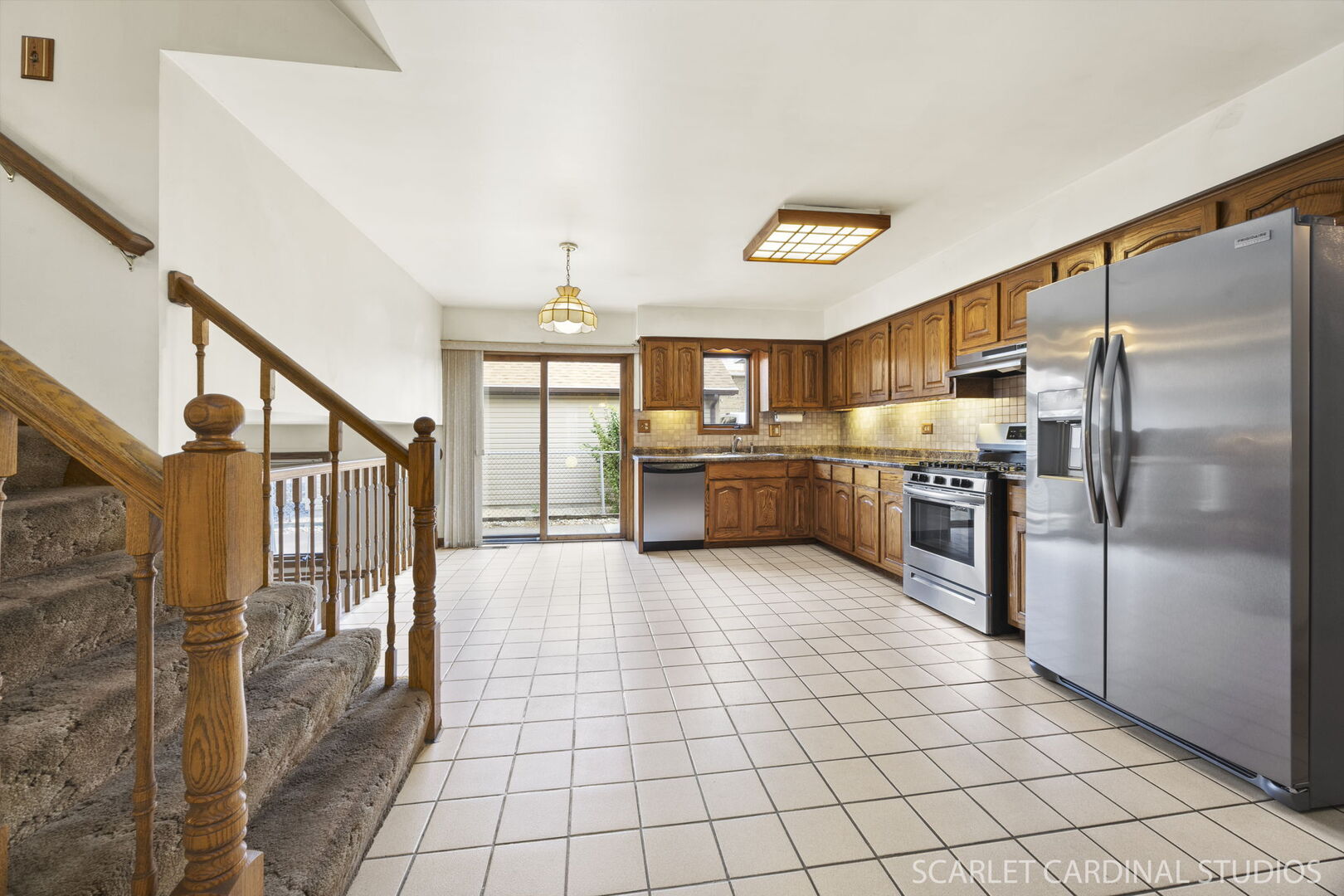 8214 45th Street Lyons, IL 60534 - Photo 3 of 24 a large kitchen with stainless steel appliances granite countertop a refrigerator and a stove top oven