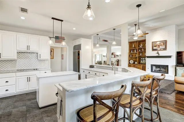 a kitchen with stainless steel appliances sink stove refrigerator and microwave