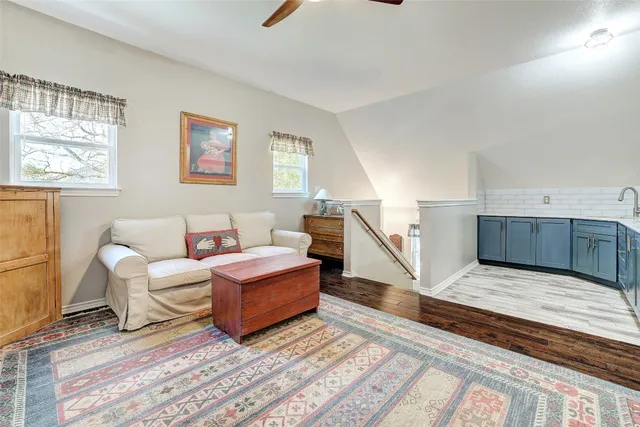 a bathroom with a granite countertop sink a toilet and shower