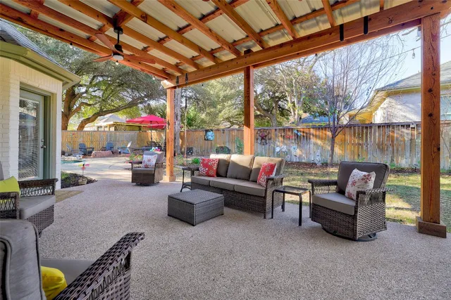 a view of pool with brick walls plants and large tree