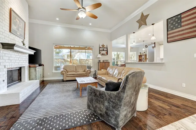 a living room with furniture a fireplace and a flat screen tv