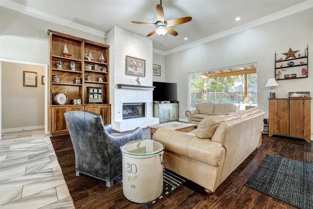 a living room with furniture a flat screen tv and a fireplace