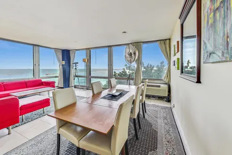 a view of a dining room with furniture window and outside view