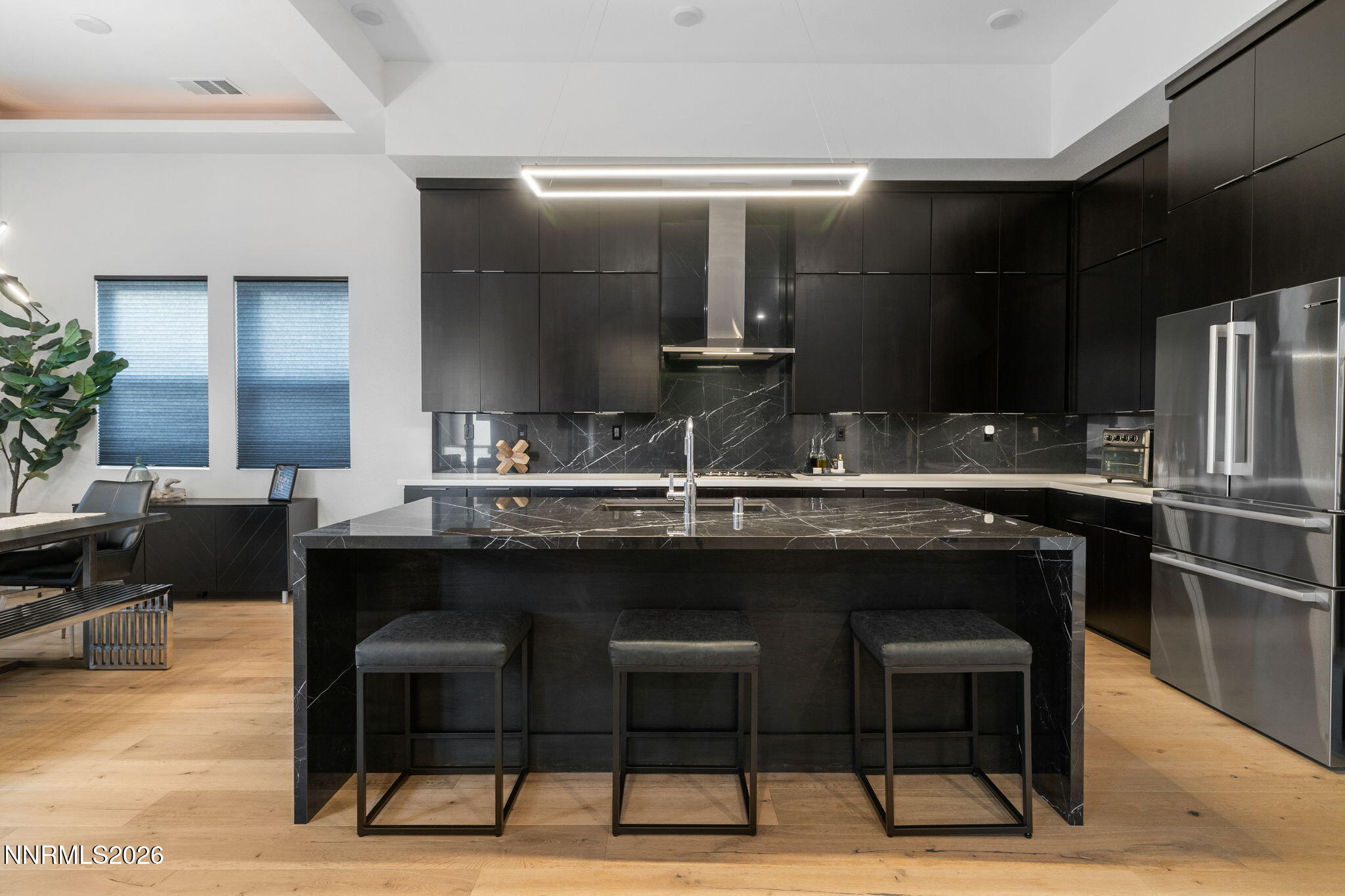 940 Little Star Drive Reno, NV 89511 - Photo 5 of 21 a kitchen with a sink and chairs
