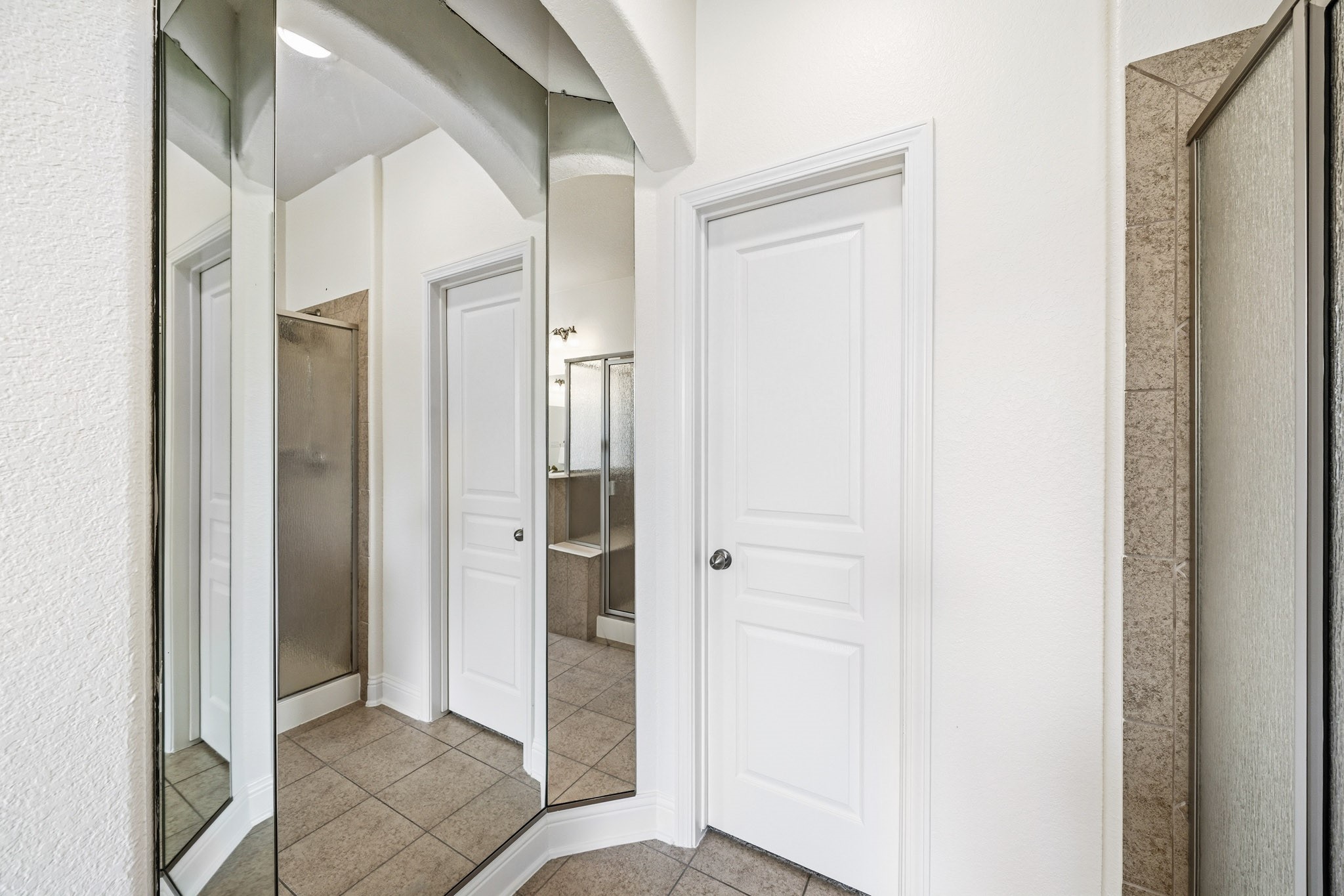 17610 Strackfield Lane Tomball, TX 77377 - Photo 27 of 50 Full-length mirrors enhance the sense of space and light, adding an elegant touch to the primary bath.