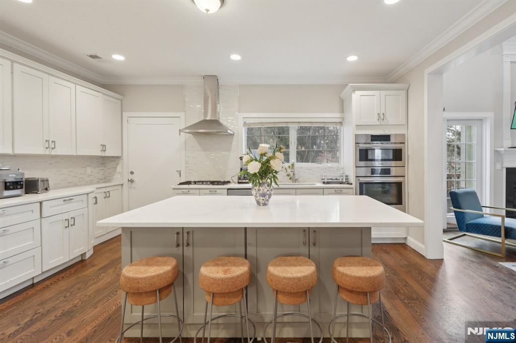 680 Soldier Hill Road Oradell, NJ 07649 - Photo 20 of 47 a large kitchen with granite countertop a table and chairs in it