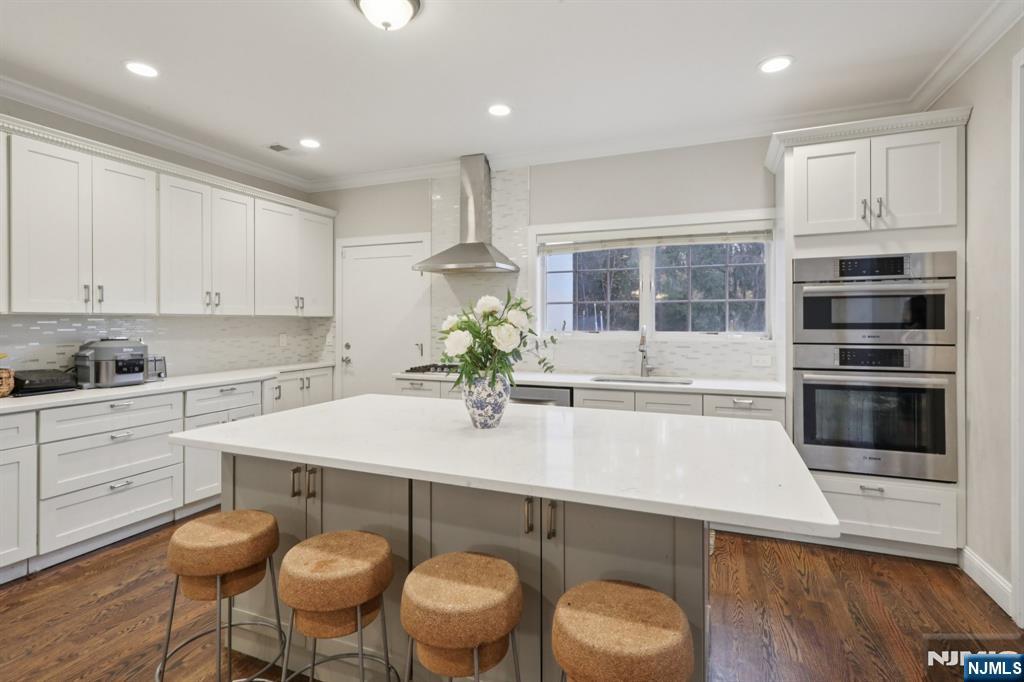 680 Soldier Hill Road Oradell, NJ 07649 - Photo 22 of 47 a kitchen with stainless steel appliances a sink a stove a microwave a center island and cabinets