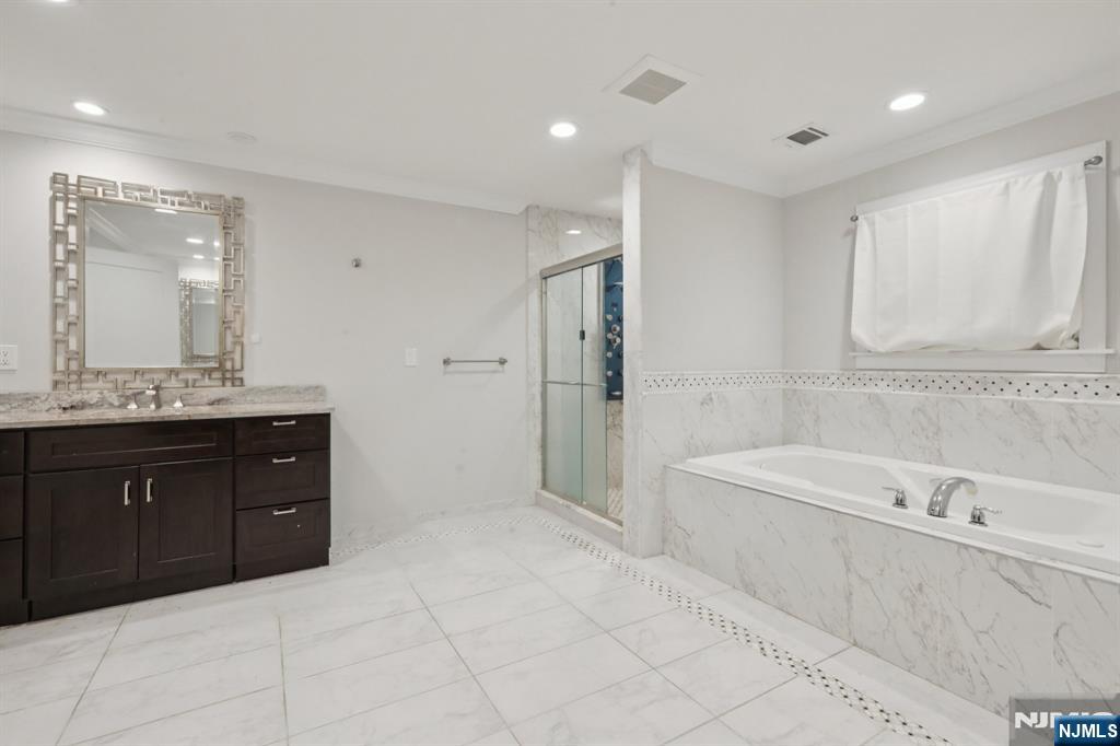 680 Soldier Hill Road Oradell, NJ 07649 - Photo 29 of 47 a bathroom with a tub sink and mirror