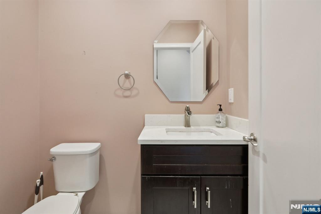 680 Soldier Hill Road Oradell, NJ 07649 - Photo 34 of 47 a bathroom with a toilet sink and mirror