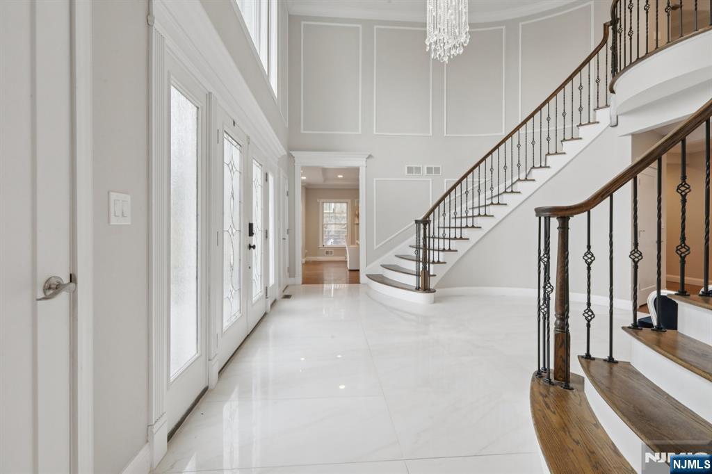 680 Soldier Hill Road Oradell, NJ 07649 - Photo 6 of 47 a view of staircase with lots of frames and couches