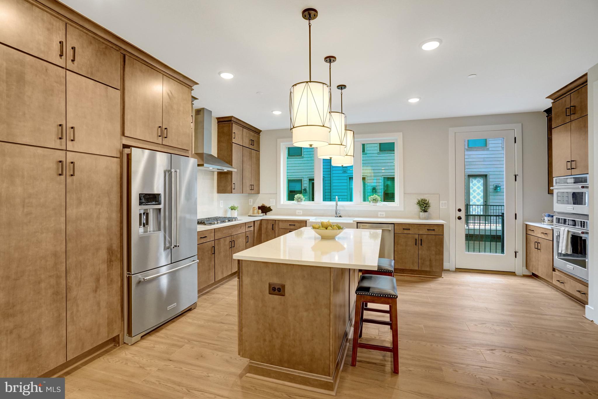 2605 Fall Line Street Alexandria, VA 22301 - Photo 31 of 71 a kitchen with stainless steel appliances granite countertop a refrigerator a sink dishwasher a stove and white cabinets with wooden floor