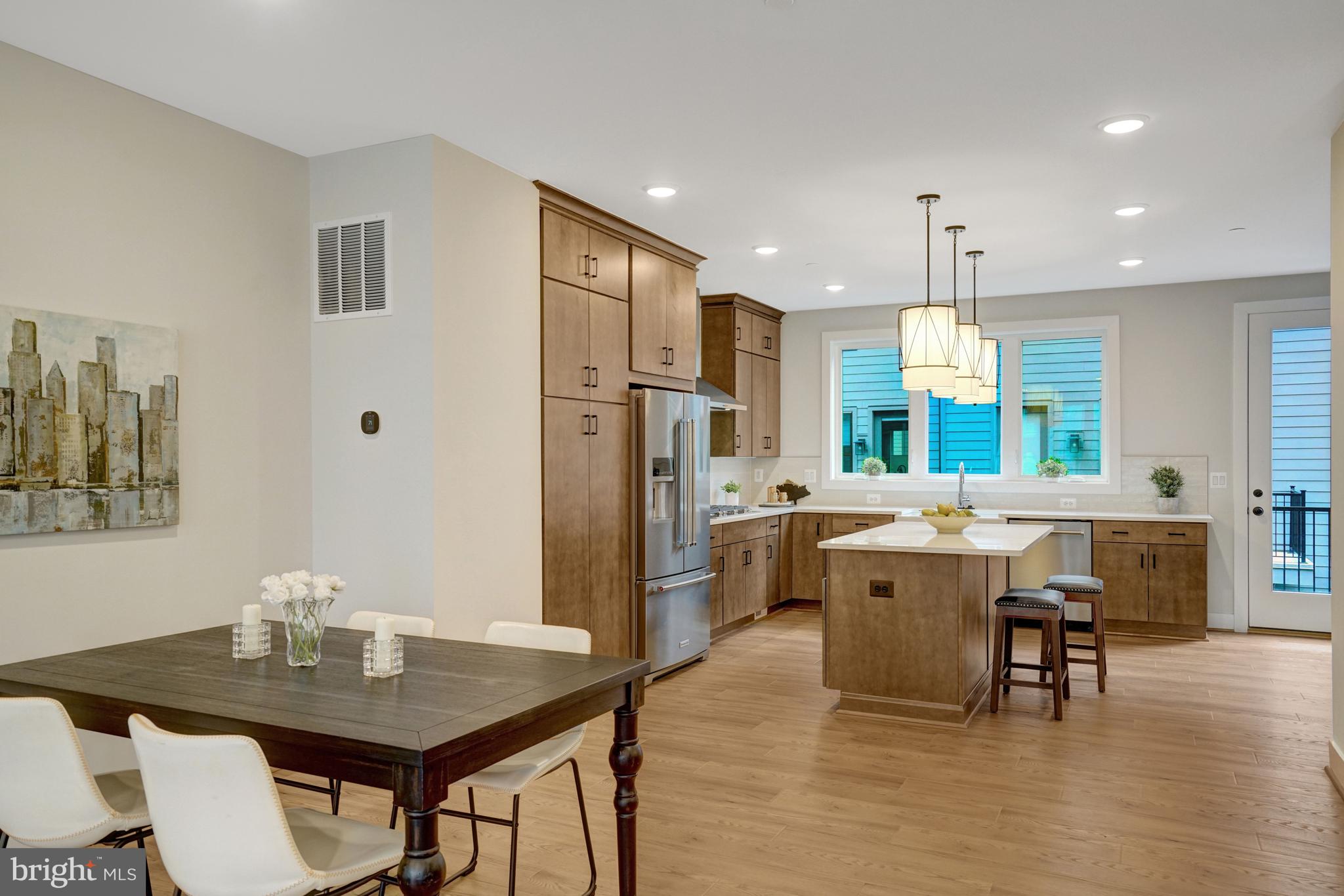 2605 Fall Line Street Alexandria, VA 22301 - Photo 36 of 71 a kitchen with stainless steel appliances granite countertop a dining table chairs refrigerator and microwave