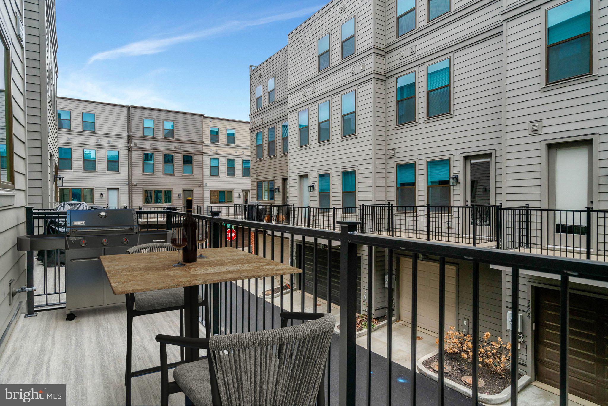 2605 Fall Line Street Alexandria, VA 22301 - Photo 40 of 71 a view of a roof deck with table and chairs and wooden floor