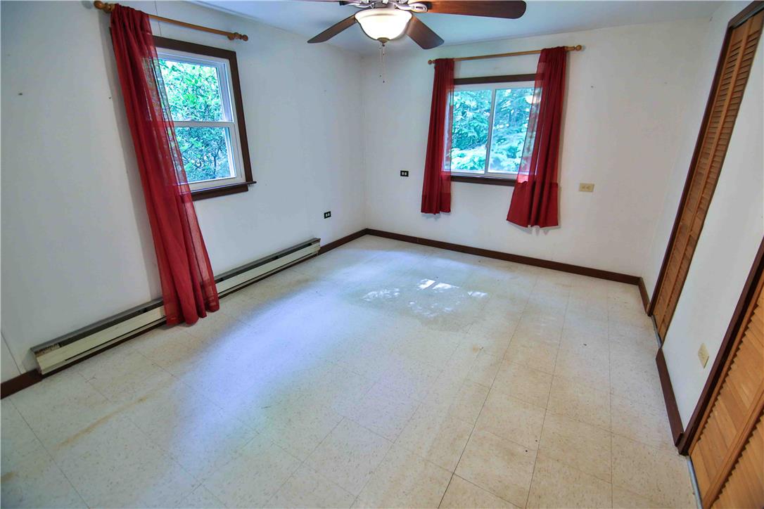 8 Cross Rds Drive Jim Thorpe, PA 18229 - Photo 14 of 32 A well-lit bedroom with ample natural light, featuring laminate flooring and a ceiling fan.