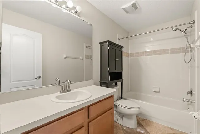 a bathroom with a sink toilet vanity and shower