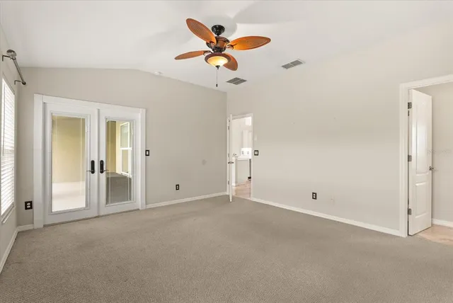 a view of an empty room with a ceiling fan