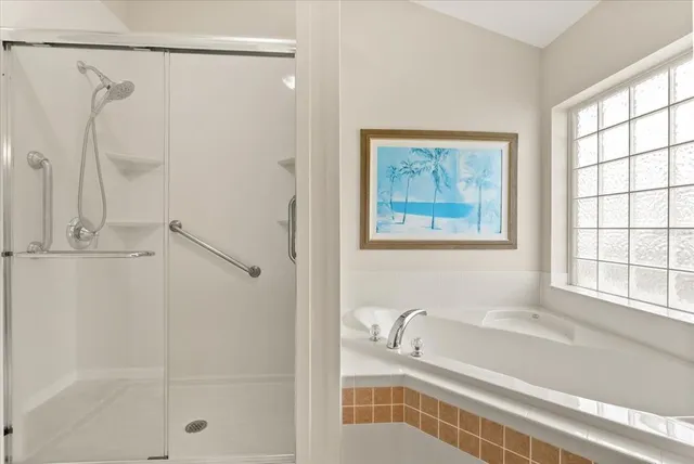 a bathroom with a granite countertop toilet a sink and shower