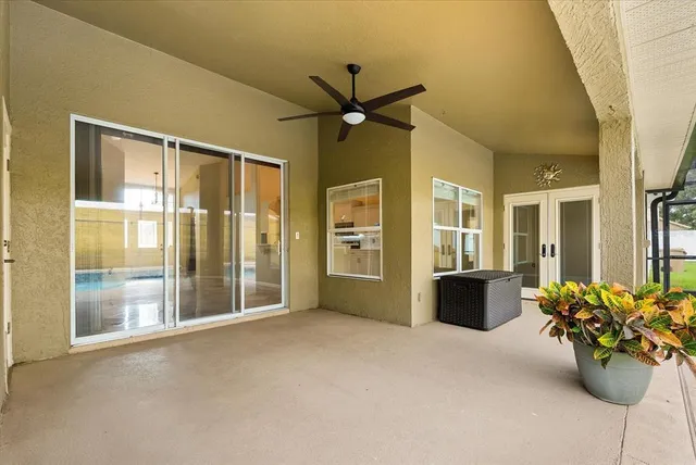 a view of a livingroom with a ceiling fan and a large window