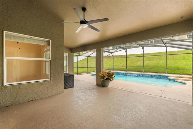 a view of a swimming pool with an outdoor seating and yard