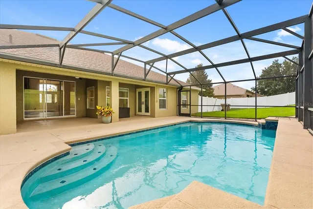 an aerial view of a residential houses with outdoor space