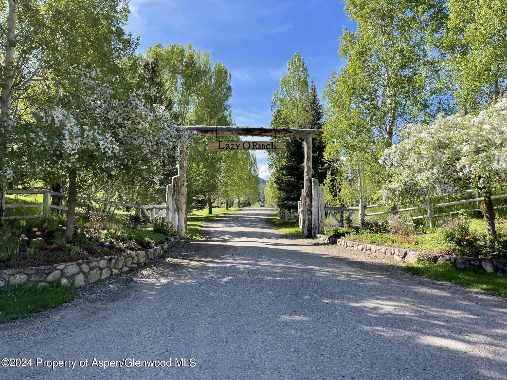 0 Lazy O Road, Unit LOT #4 Snowmass, CO 81654 - Photo 12 of 25 a view of a house with large tree and plants