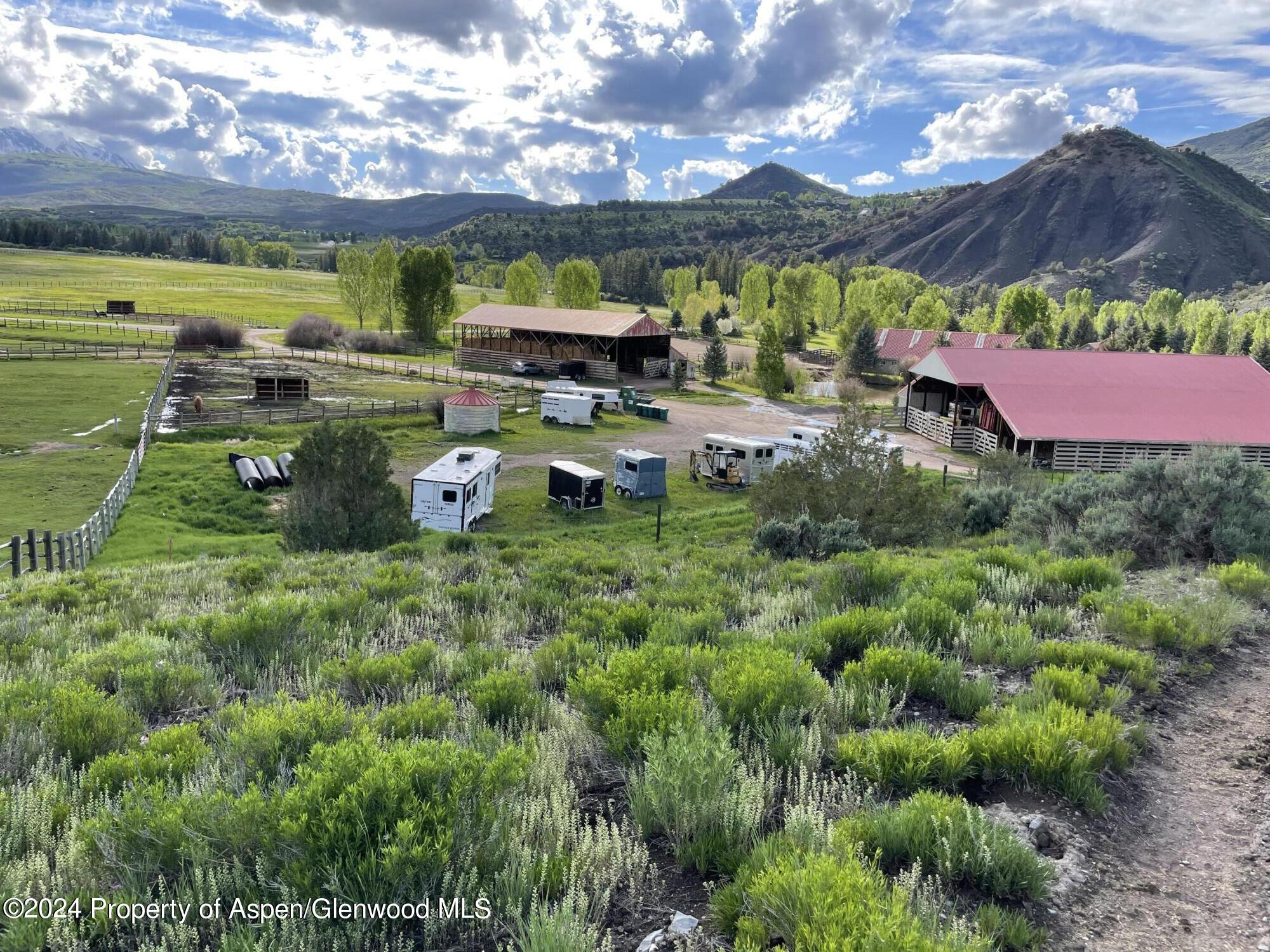 0 Lazy O Road, Unit LOT #4 Snowmass, CO 81654 - Photo 10 of 25 a backyard of a house with a garden and mountain view
